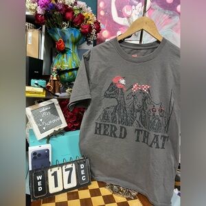 Herd That" graphic print featuring three goats wearing accessories.